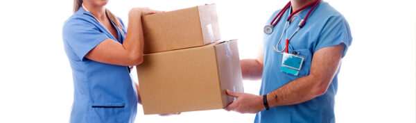 a man and a woman in scrubs are holding cardboard boxes