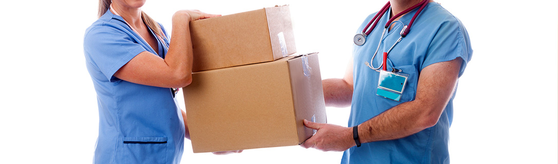 a man and a woman in scrubs are holding cardboard boxes