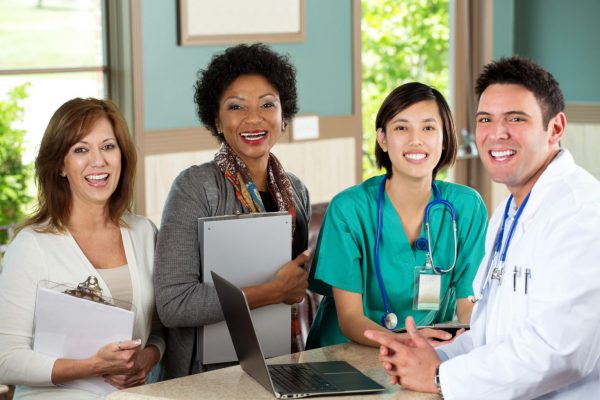 Medical staff looking up from their work and smiling.