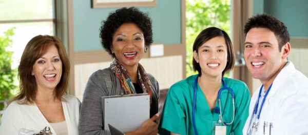 Medical staff looking up from their work and smiling.