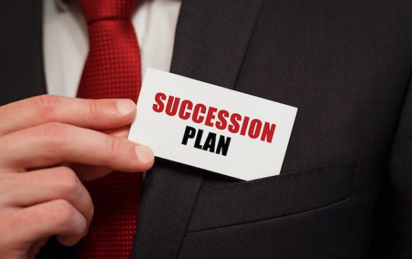 A small card labeled "succession plan" pulled from a shirt pocket.