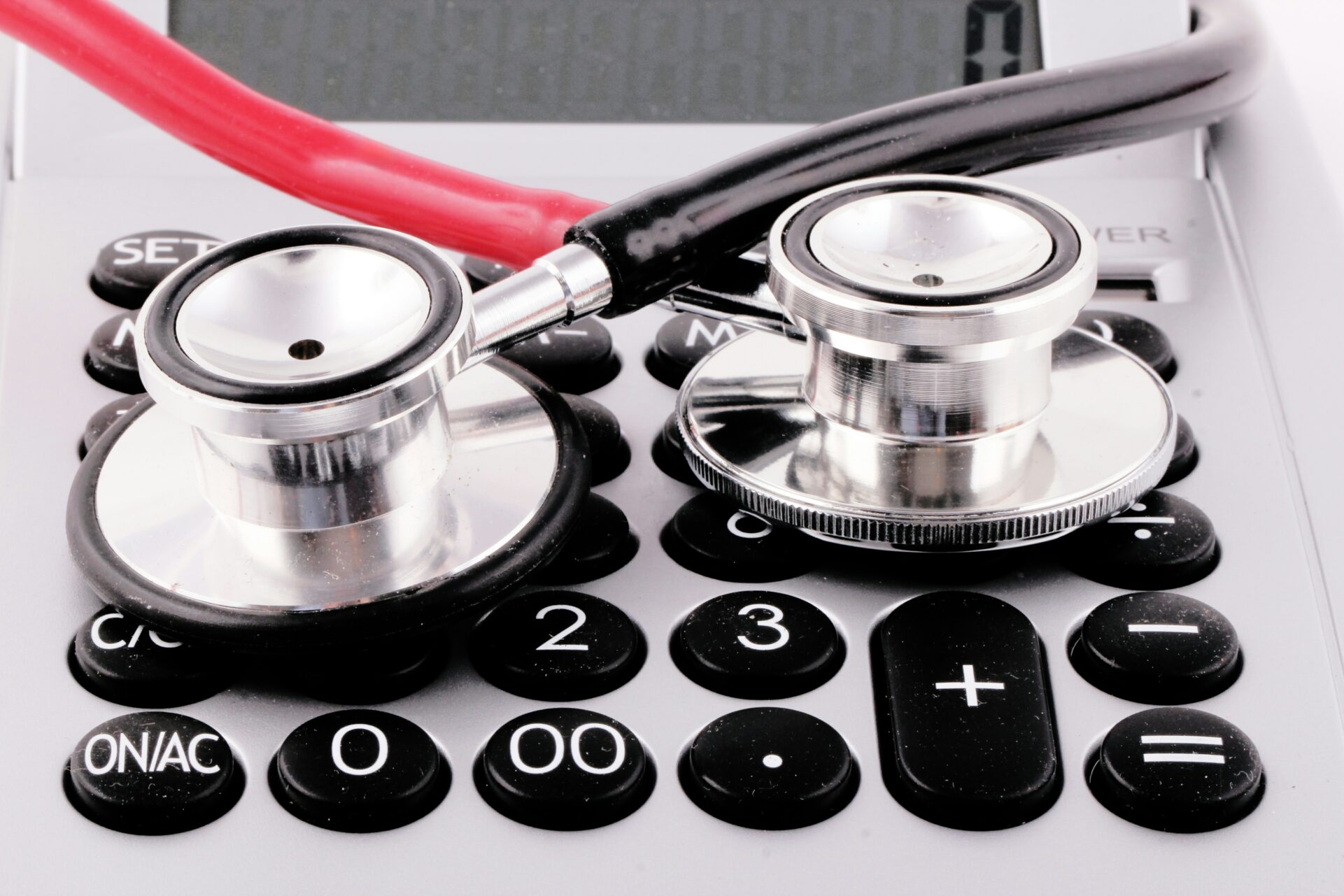 a stethoscope rests on top of a calculator