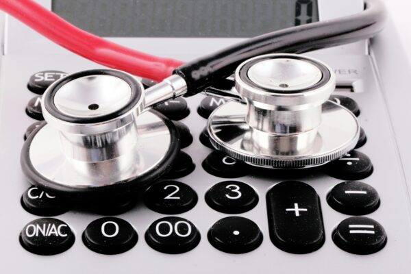 a stethoscope rests on top of a calculator
