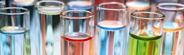 Glasses containing different chemicals lined up.