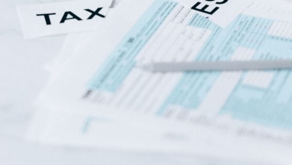 A clock beside financial documents, representing the 60-day overpayment refund deadline