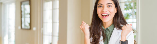 Happy female doctor with her hands up.