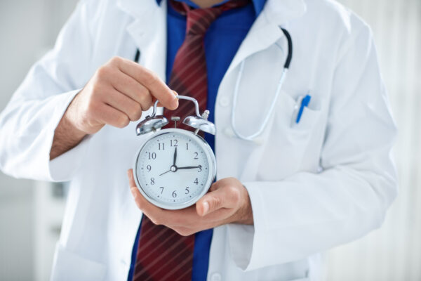 doctor holding a clock.