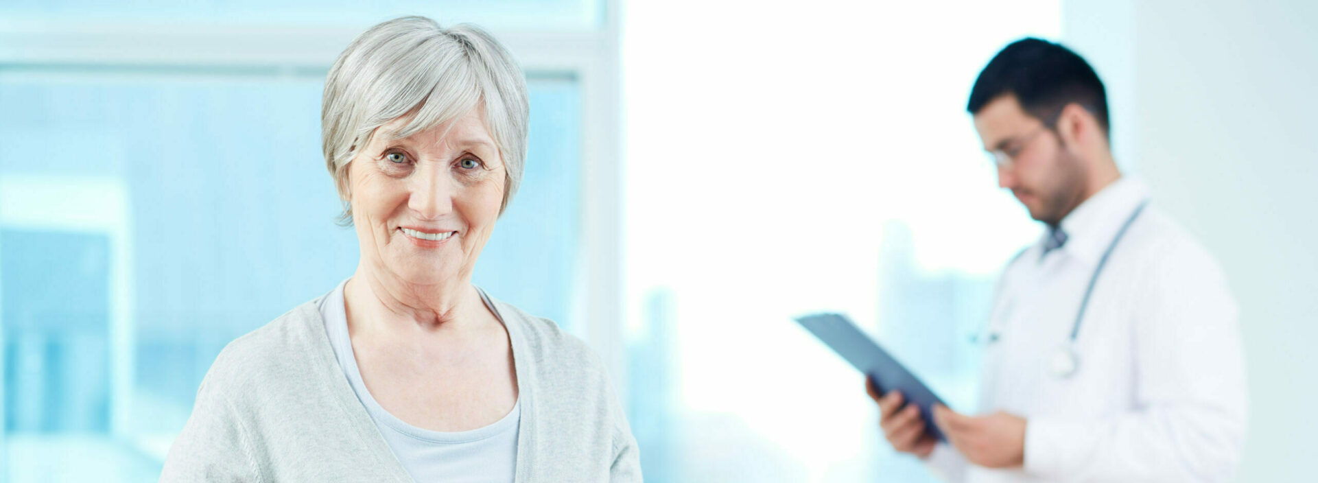 patient smiling with doctor in background