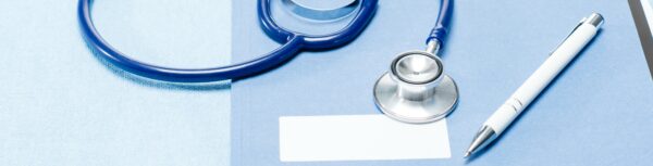 a stethoscope, pen, and name tag are on a blue table